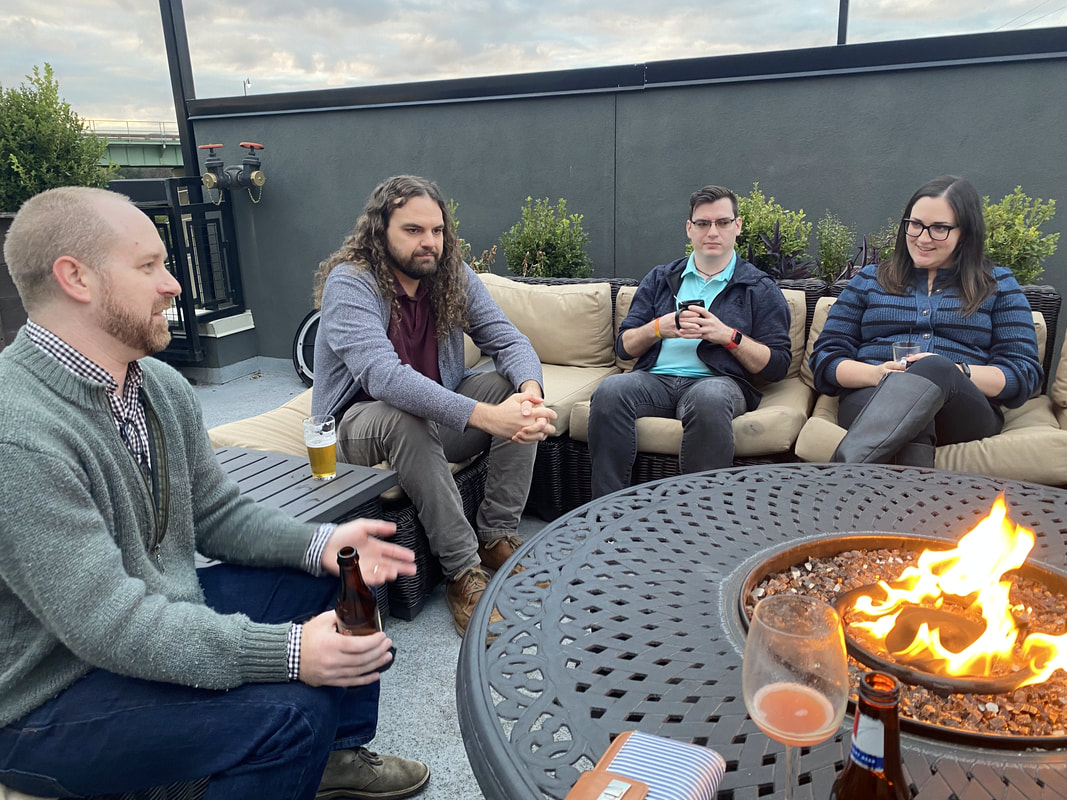 A group of people sitting around a fire pit